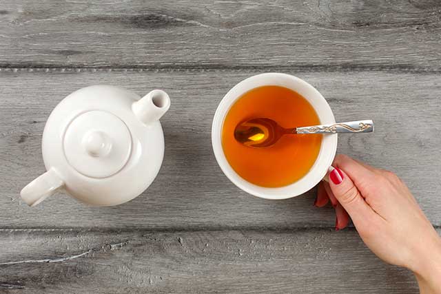 A Teapot and a Cup of Lady Grey Black Tea.