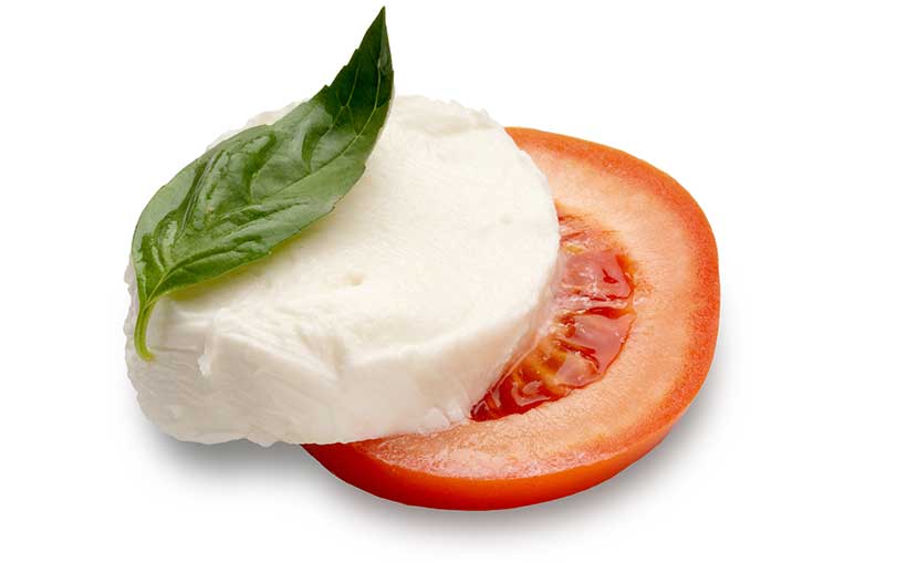 A Slice of Low-Fat Mozzarella On Top of a Slice of Tomato.