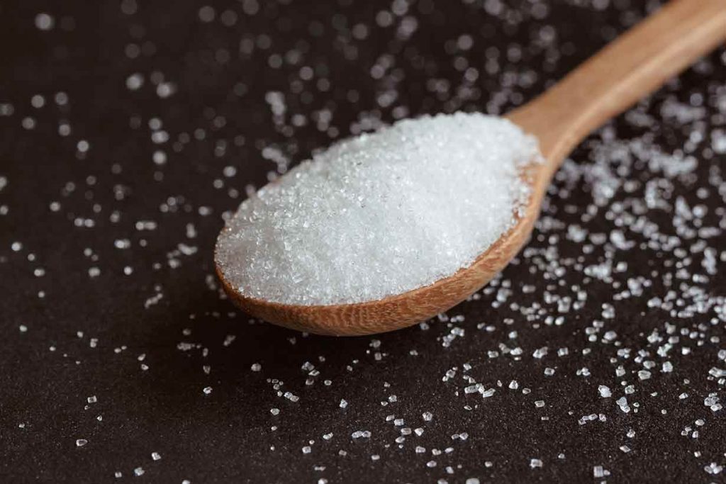 Allulose Sweetener On a Wooden Spoon.