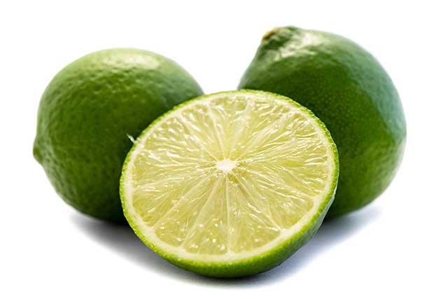Whole Limes and a Lime Half On a White Background.