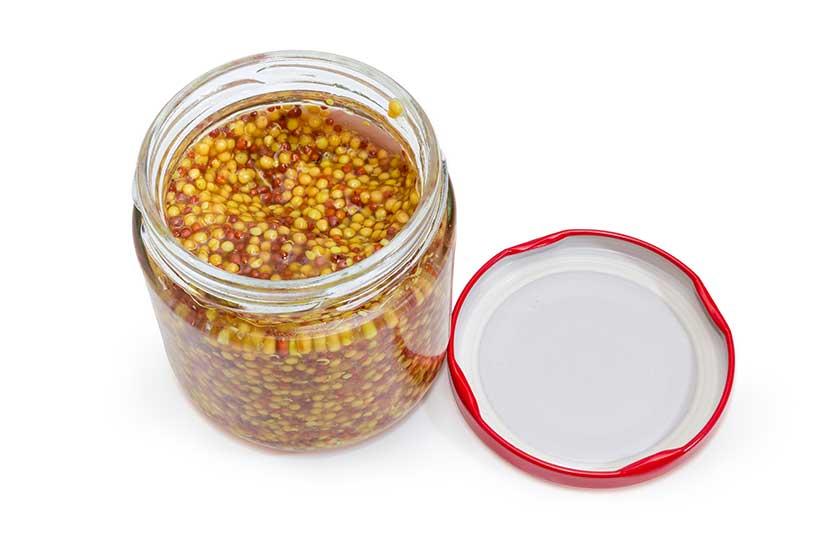 A Glass Jar of Wholegrain Mustard With the Lid Off.