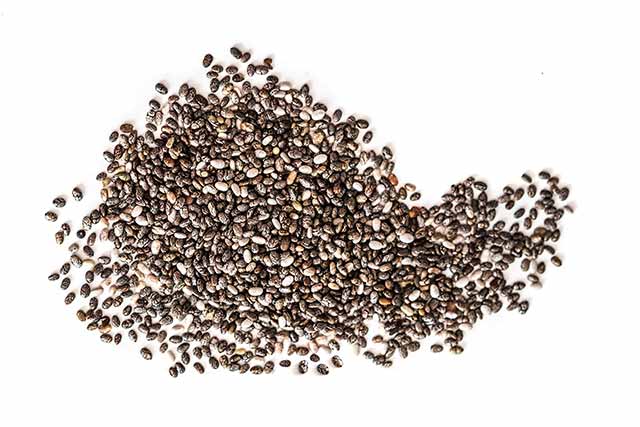 A Large Pile of Chia Seeds On a White Background.