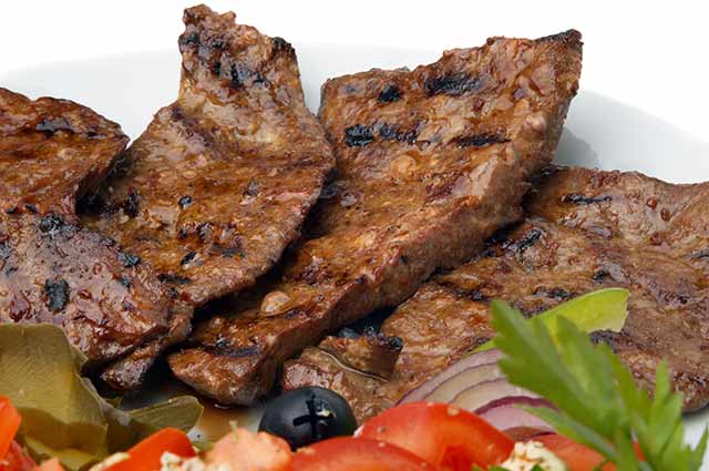 Fried Beef Liver On a Plate With vegetables.