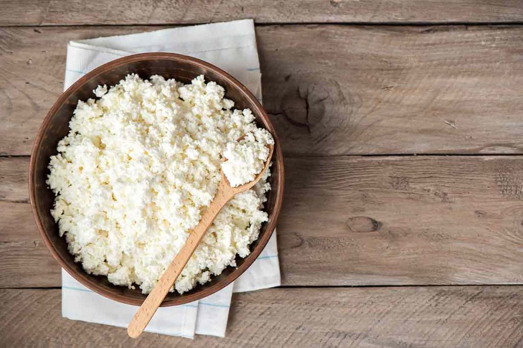 A Homemade Cottage Cheese Recipe In a Wooden Bowl.