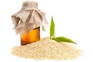 Sesame Oil Next To a Pile of Seeds.