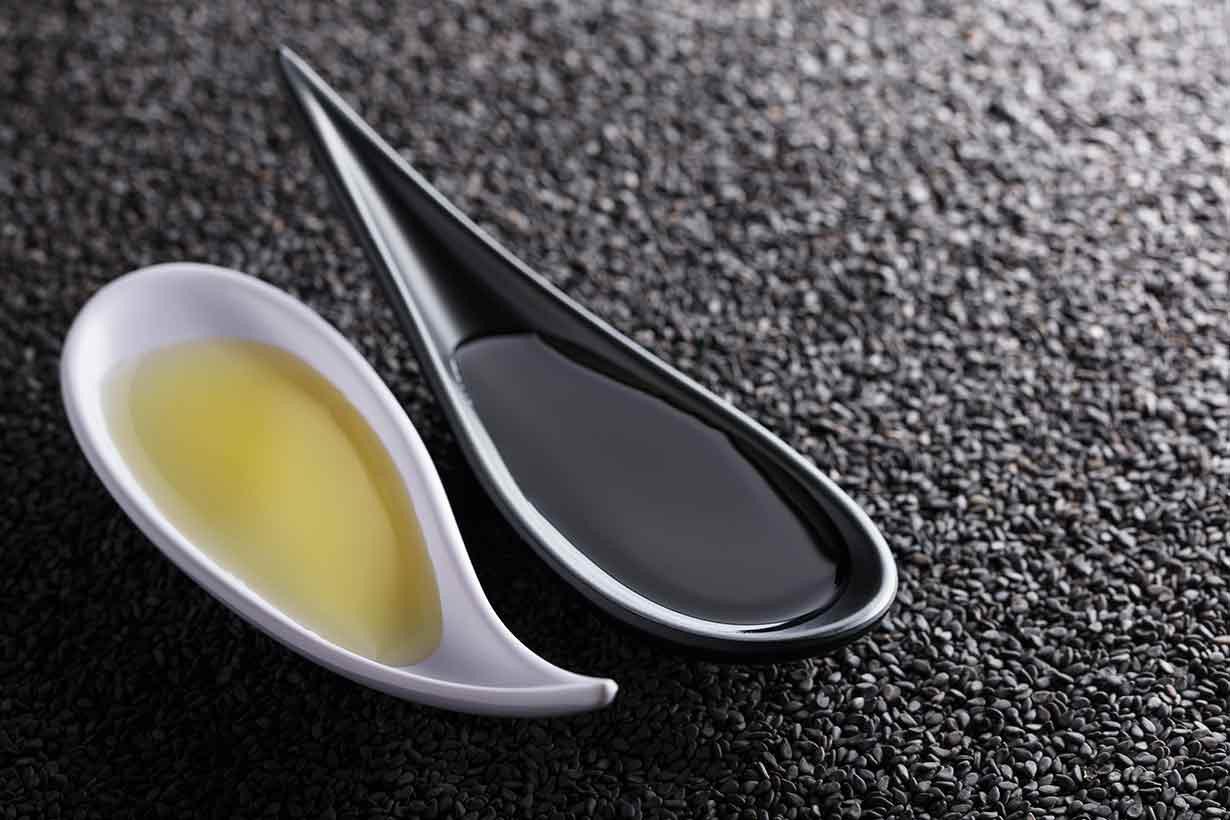 Golden Sesame Oil and Toasted Sesame Oil On Two Spoons.