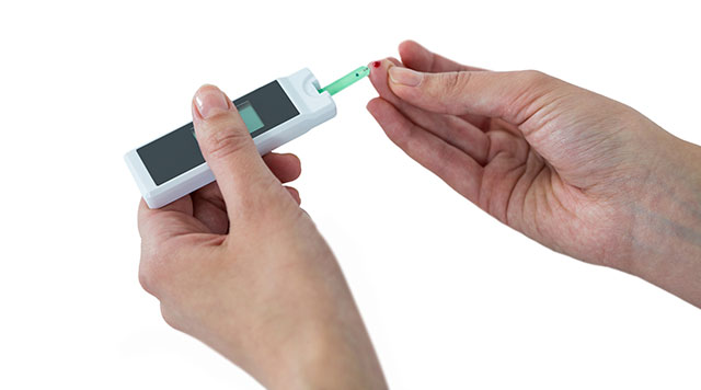 Someone Testing Their Blood Glucose Levels With a Glucometer.