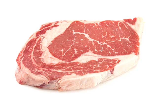 A Thick Raw Rib-eye Steak With Marbling