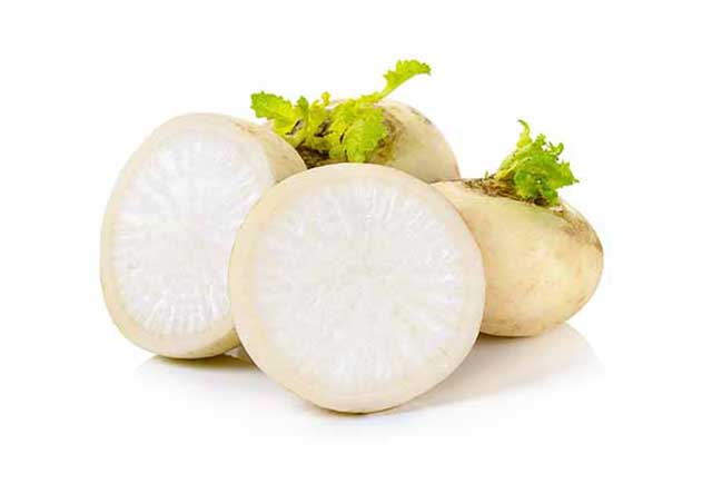 Whole and Half Turnips On a White Background.