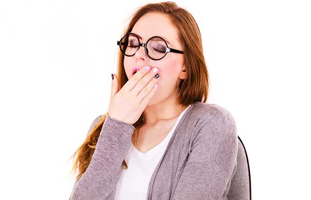 A Woman Suffering From Lack of Sleep Yawning.