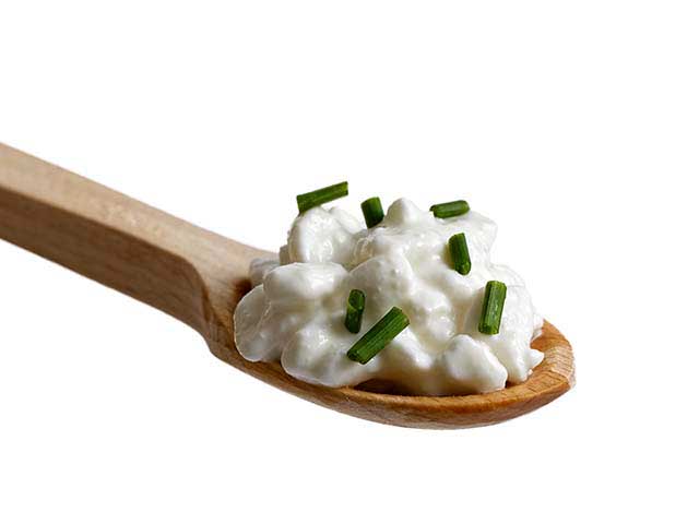 A Wooden Spoon of Homemade Cottage Cheese With Chives.