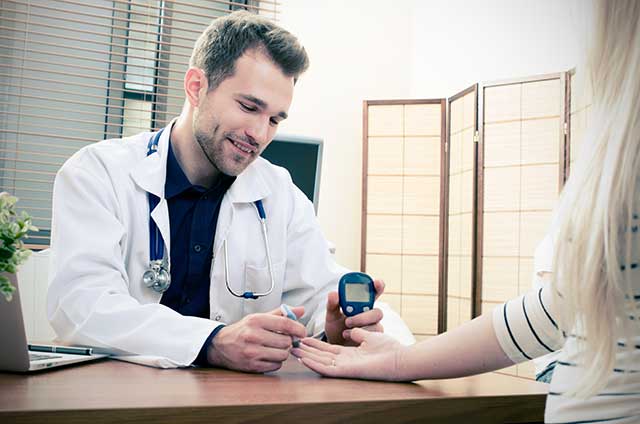 A Doctor Testing The Blood Glucose of a Patient.