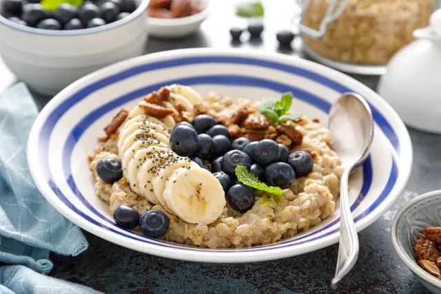 A bowl of high-protein oatmeal with fruit and nuts.