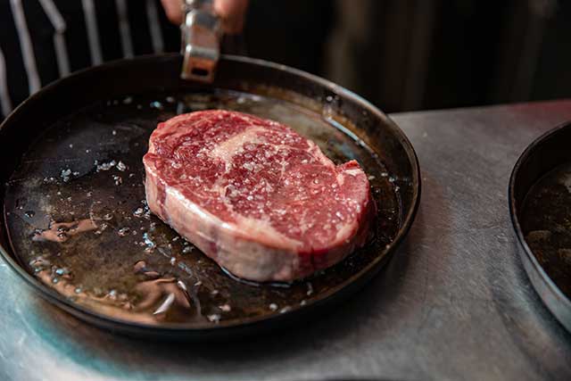 Pan Searing Raw Ribeye Steak In a Cast Iron Skillet.