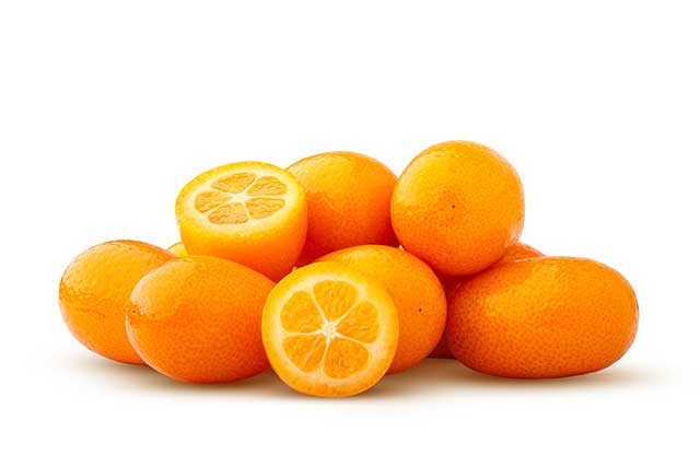 A Pile of Whole and Half Kumquat Fruit.