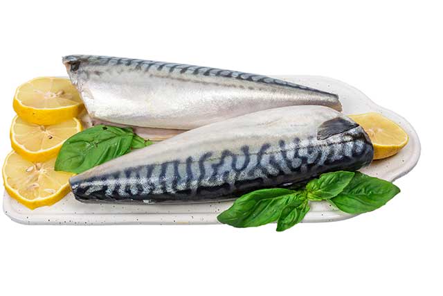 Raw Mackerel On a Kitchen Board With Lemon Slices.