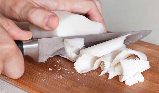 Cutting Beef Tallow With a Knife On a Chopping Board.