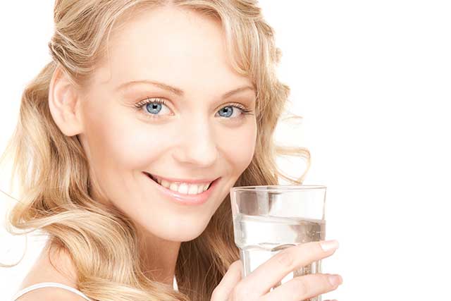 Young Woman Drinking a Glass of Water.