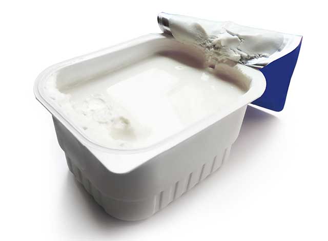 A Tub of Quark Cheese With Its Lid Peeled Off.