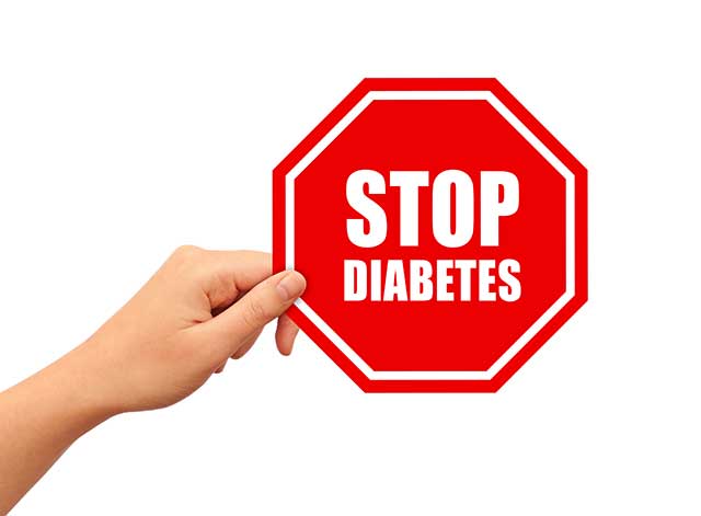 A Hand Holding a Sign Saying "Stop Diabetes".