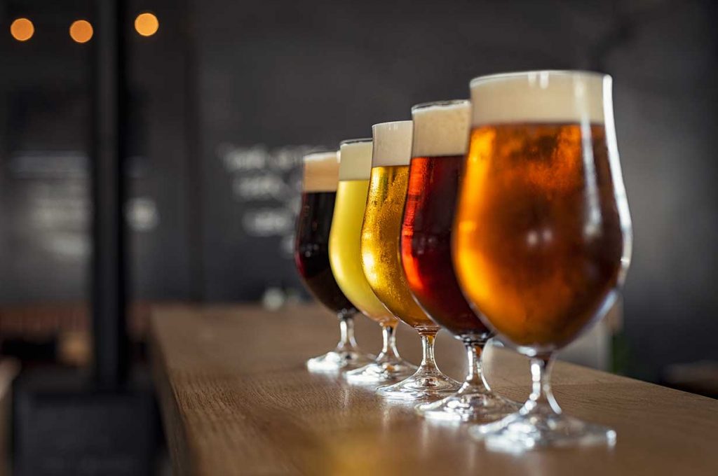 Four Different Beer Varieties In Wine Glasses.