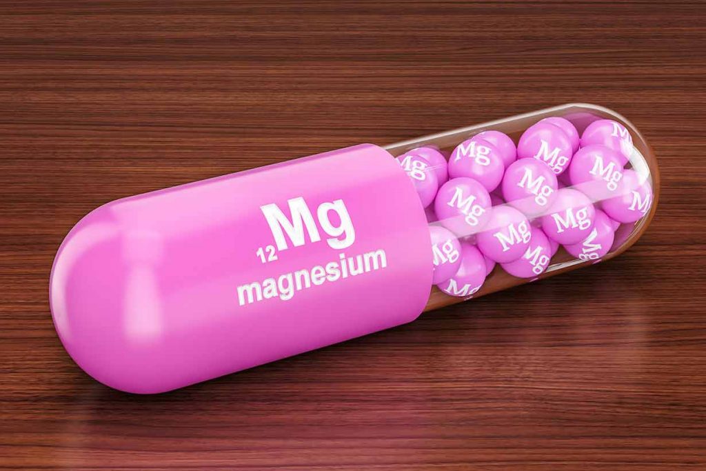 Magnesium Supplements Inside a Giant Capsule With 'Mg' Written On It.