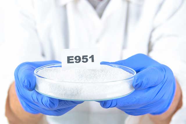 Scientist Holding Food Additive Number E951 (Aspartame).