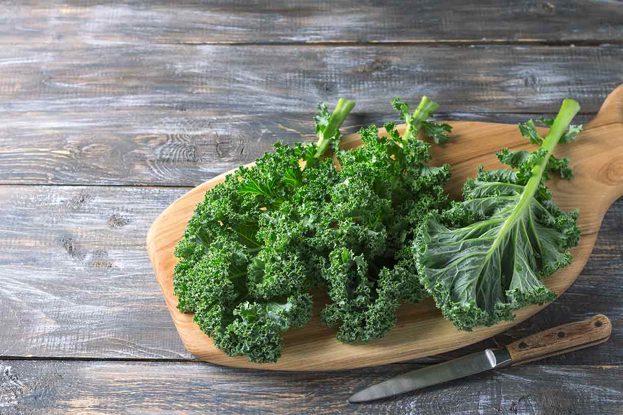 Kale Leaves On a Wooden Board.