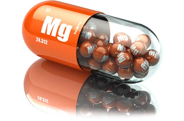 Magnesium Supplement Tablets Inside a Giant Capsule With 'Mg' On It.
