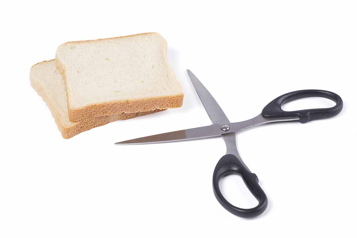 A Pair of Scissors Cutting a Slice of Bread (Cutting Carbs Theme).