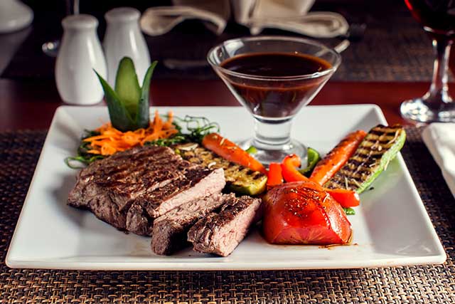 Beef Steak With Grilled Vegetables On a White Squared Plate.