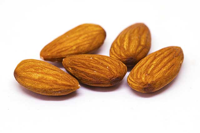 Close-up Photo of Five Almond Nuts.