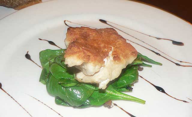 Cooked Sweetbread On Leafy Greens.