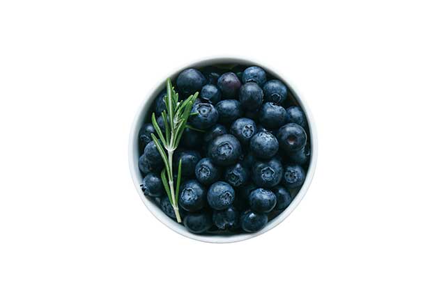 Fresh Wild Blueberries In a White Bowl.