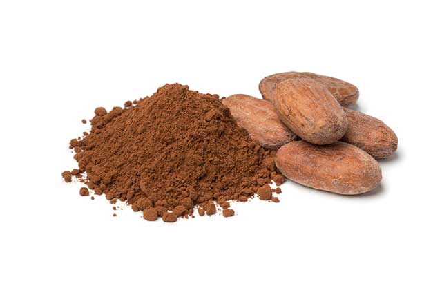 Heap of Cocoa Powder Next To Whole Cocoa Beans.