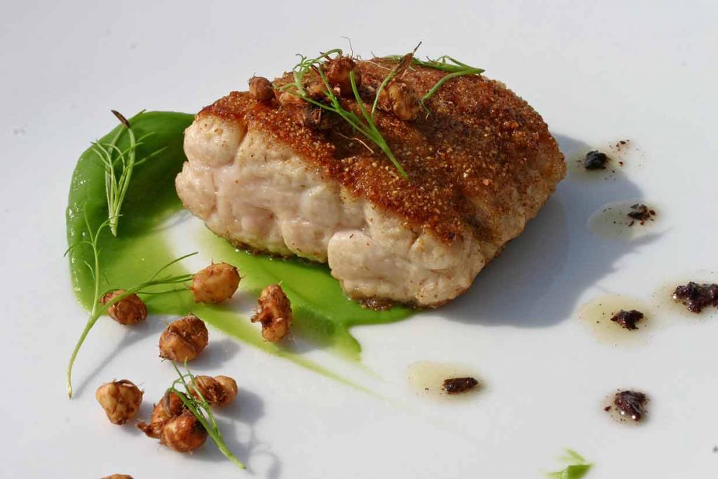 Sweetbreads On a White Plate With Various Sides.