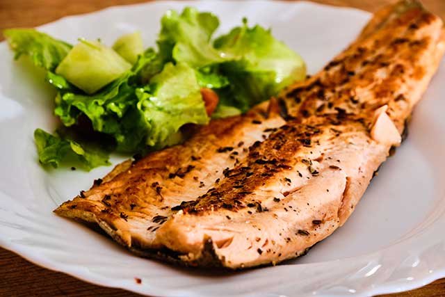 Baked Rainbow Trout On a Plate With Vegetables.