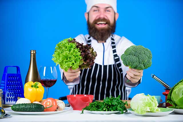 Chef With Table of Vegan Foods.