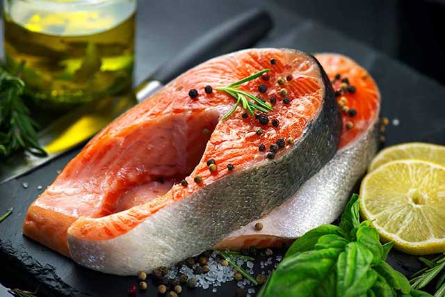 Rainbow Trout Fillet On Plate With Vegetables and Lemon.