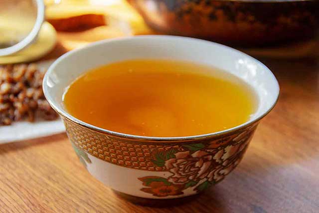 Liquid Goose Fat In a Bowl On a Wooden Table.