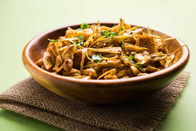 A Meal In a Bowl That Contains Cooked Jackfruit.