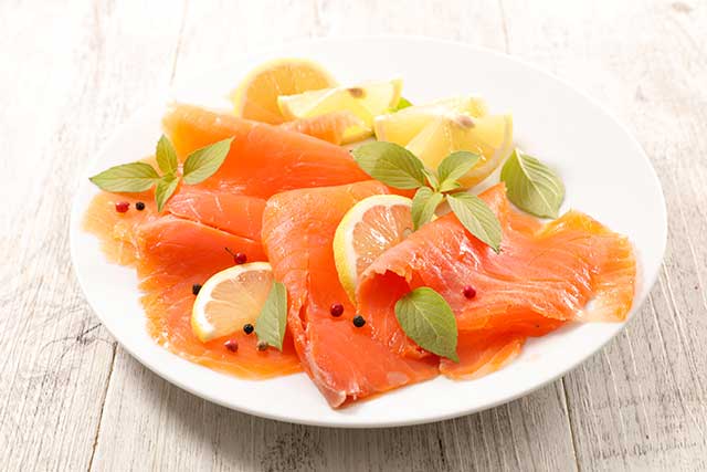 Plate of Smoked Salmon With Citrus Fruit.