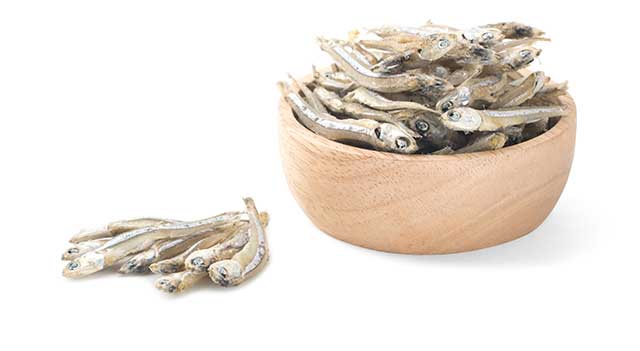 Dried Anchovies In a Wooden Bowl.