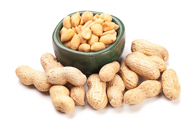 Roasted Peanuts In a Bowl Next To Peanuts In Shells.