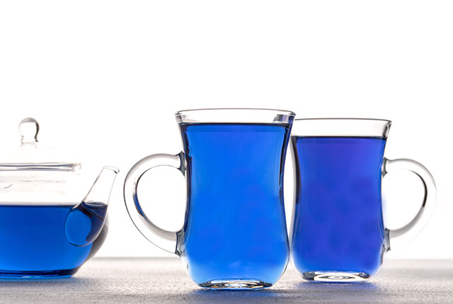 Butterfly Pea Flower Tea In a Glass Teapot and Two Glasses.