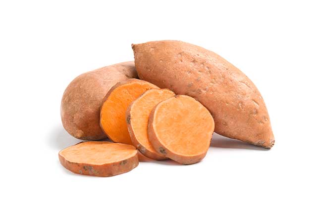 Fresh Sliced Sweet Potatoes and Two Whole Sweet Potatoes.