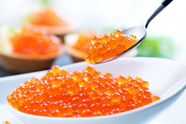 Salmon Roe Fish Eggs In White Dish and On a Spoon.