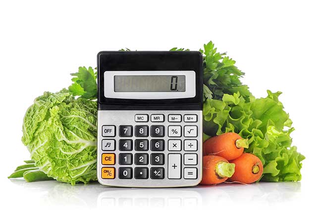 Calculator Next To Various Vegetables (Calorie Counting Theme).