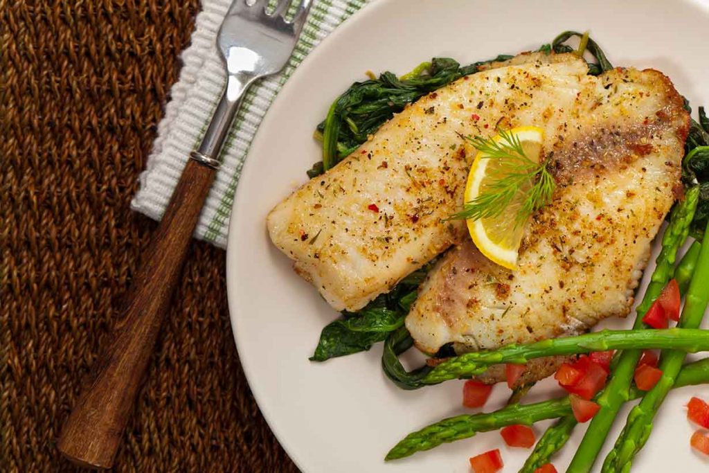 Grilled Catfish Fillets On a White Plate.