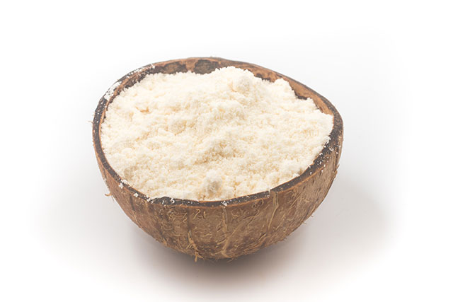 Coconut Flour In Half a Coconut Shell.